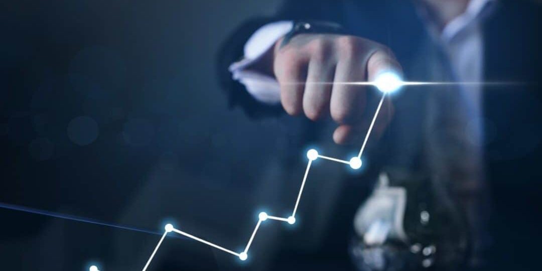 business growth and sales increase man using finger to draw line chart with light